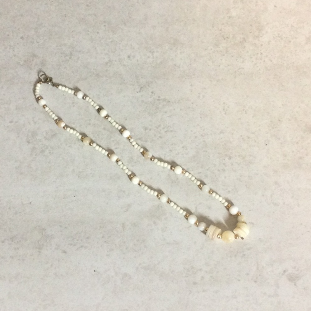 Shell with white and gold beads necklace